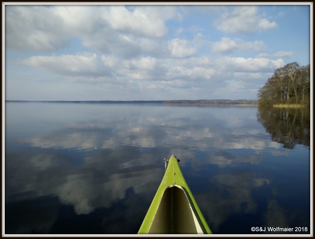 Canoeing on a calm day, the lake is like a painting.